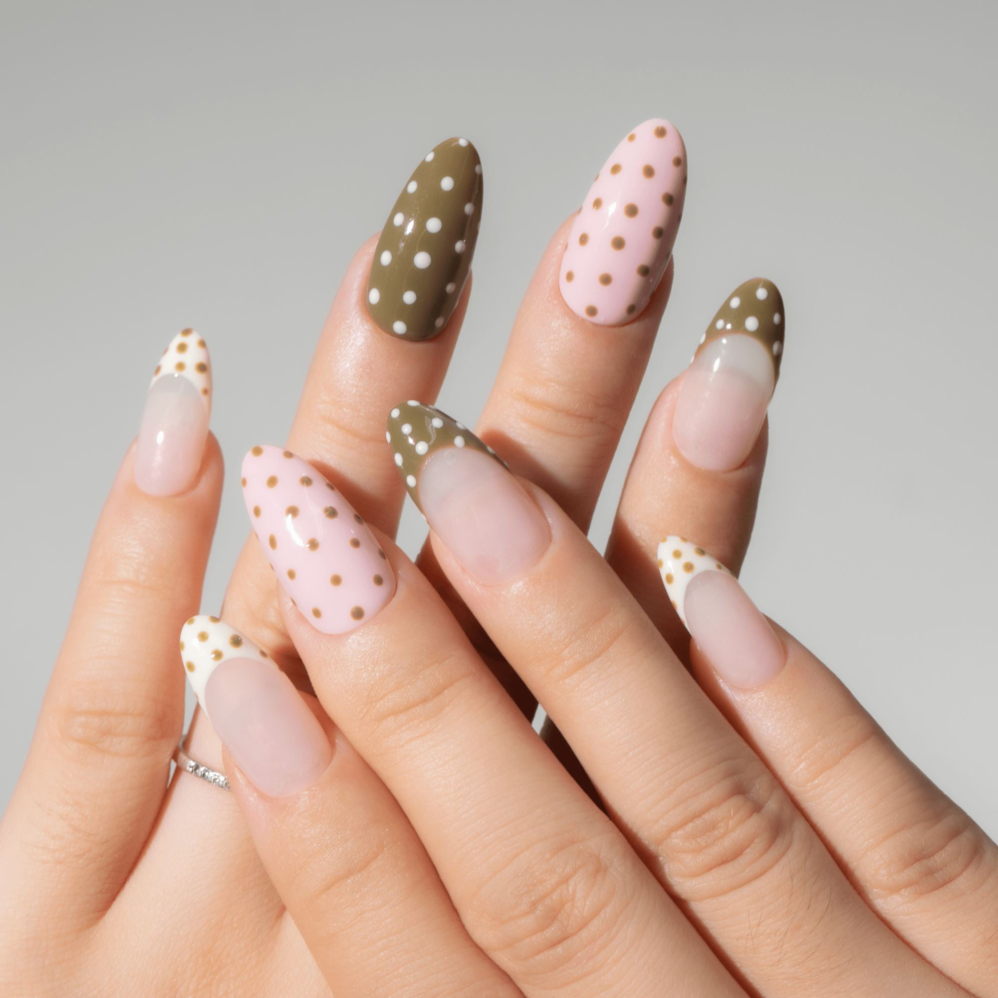 Polka Pop press-on nails worn on hand – almond shape by Handora