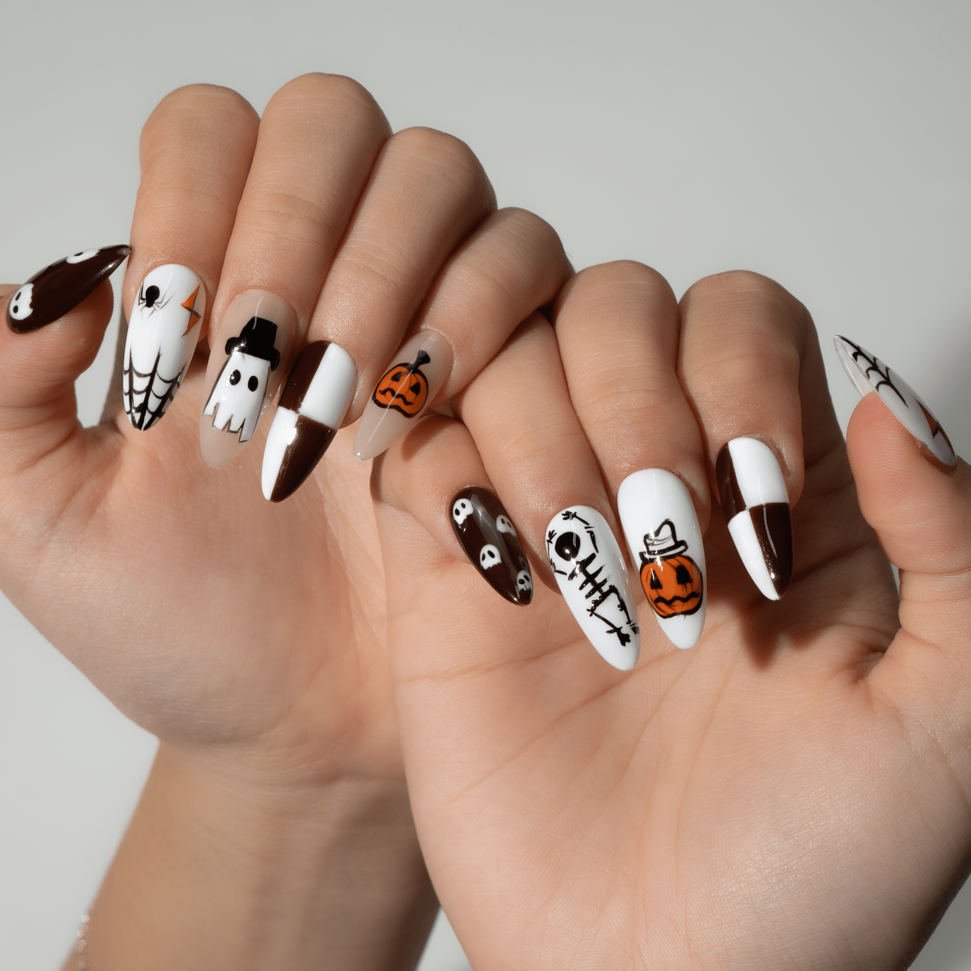 Pumpkin Party press-on nails worn on hand – almond shape by Handora