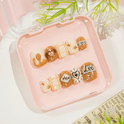 Puppy Leo press-on nails worn on hand – almond shape by Handora