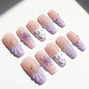 Purple Bloom press-on nails worn on hand – almond shape by Handora