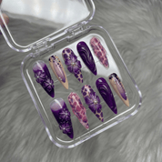 Purple Petals press-on nails worn on hand – almond shape by Handora