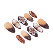 Red Bloom press-on nails worn on hand – almond shape by Handora
