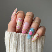 Royal Rosette press-on nails worn on hand – almond shape by Handora