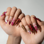 Ruby Bloom press-on nails worn on hand – almond shape by Handora