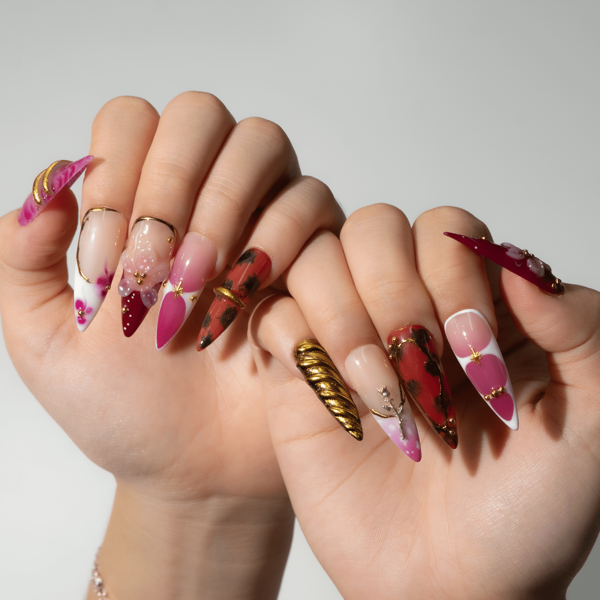 Ruby Bloom press-on nails worn on hand – almond shape by Handora