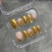 Ruby Polka press-on nails worn on hand – almond shape by Handora