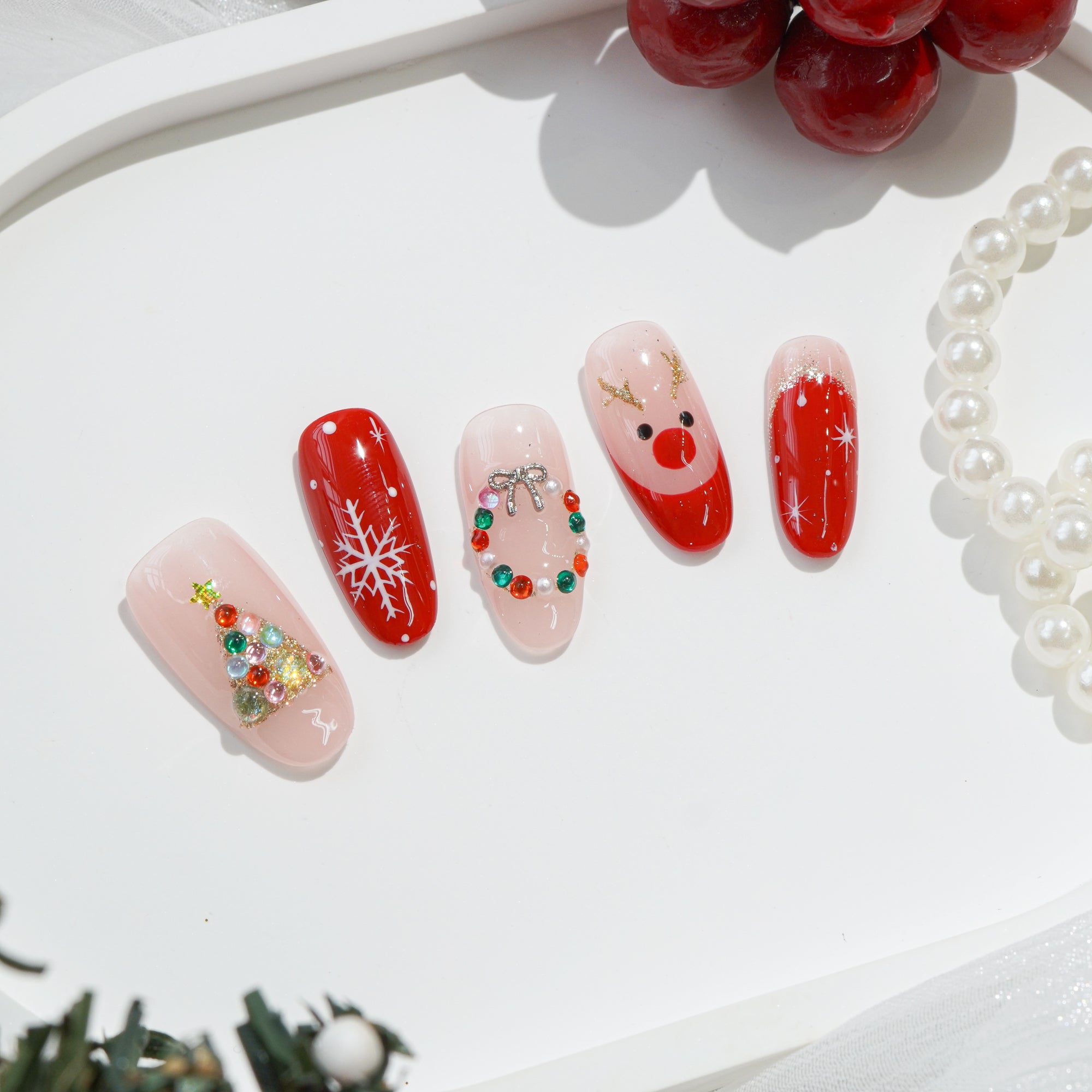 Rudolph’s Kiss almond press-on nails – design close-up by Handora