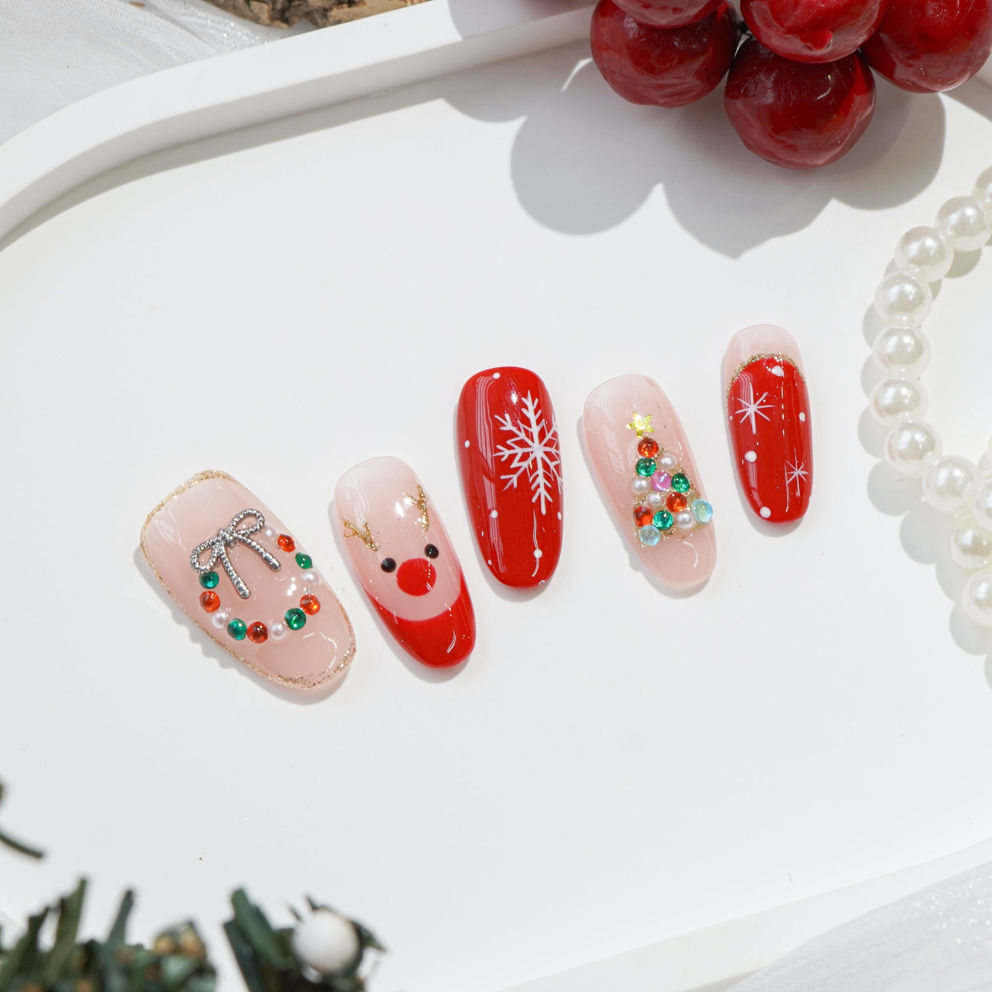 Rudolph’s Kiss press-on nails – hand-painted reusable gel set by Handora
