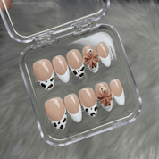 Safari Bloom press-on nails worn on hand – almond shape by Handora