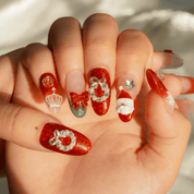 Santa Chic press-on nails worn on hand – almond shape by Handora