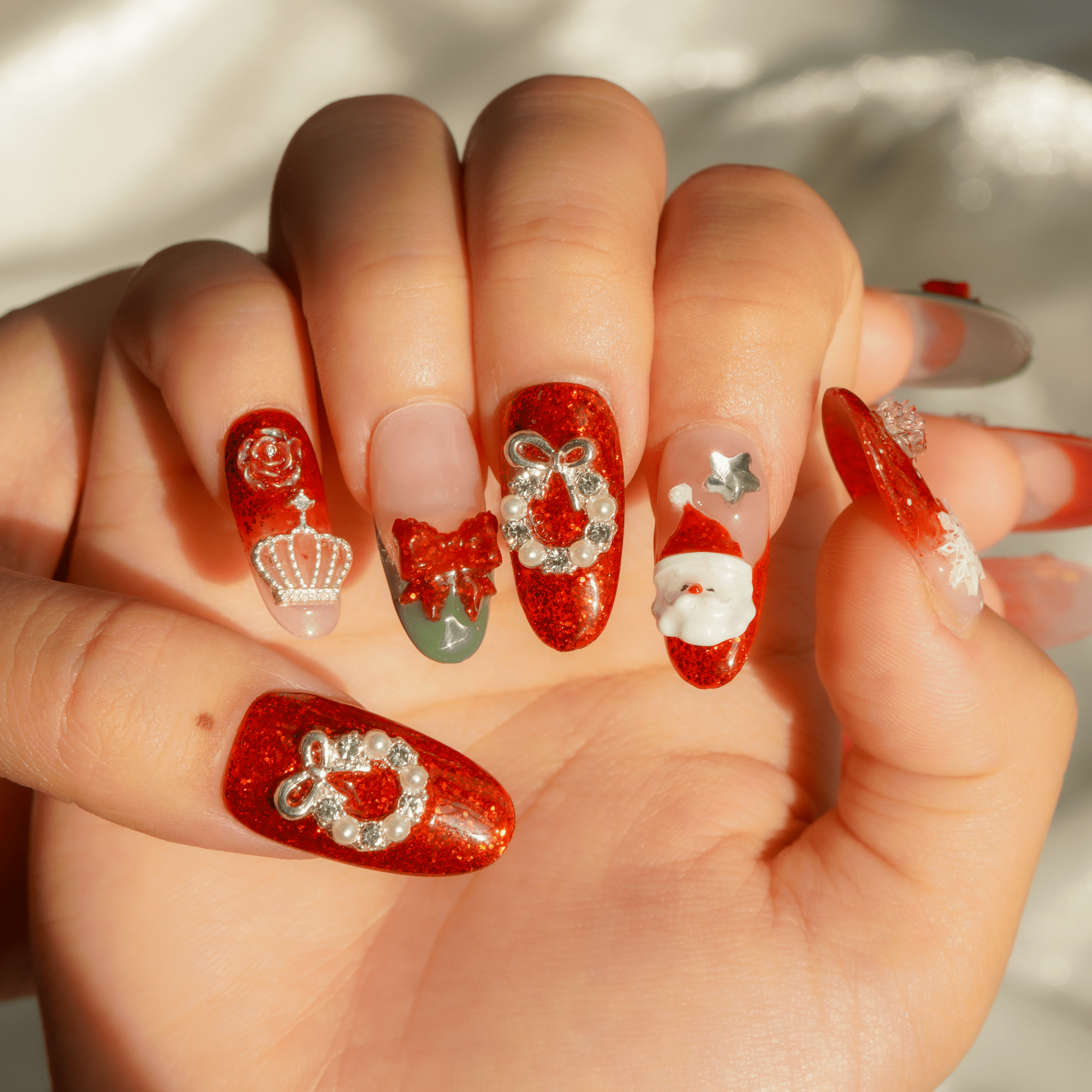 Santa Chic press-on nails worn on hand – almond shape by Handora