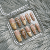 Scallop Seashell press-on nails worn on hand – almond shape by Handora