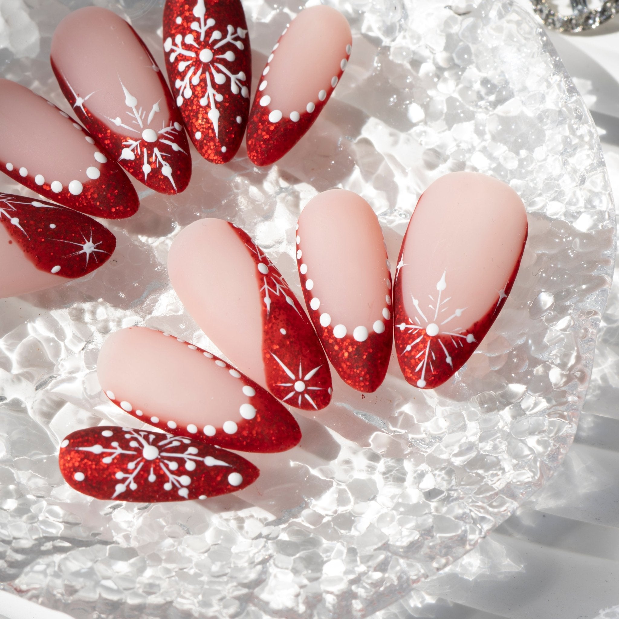 Scarlet Snow press-on nails worn on hand – almond shape by Handora