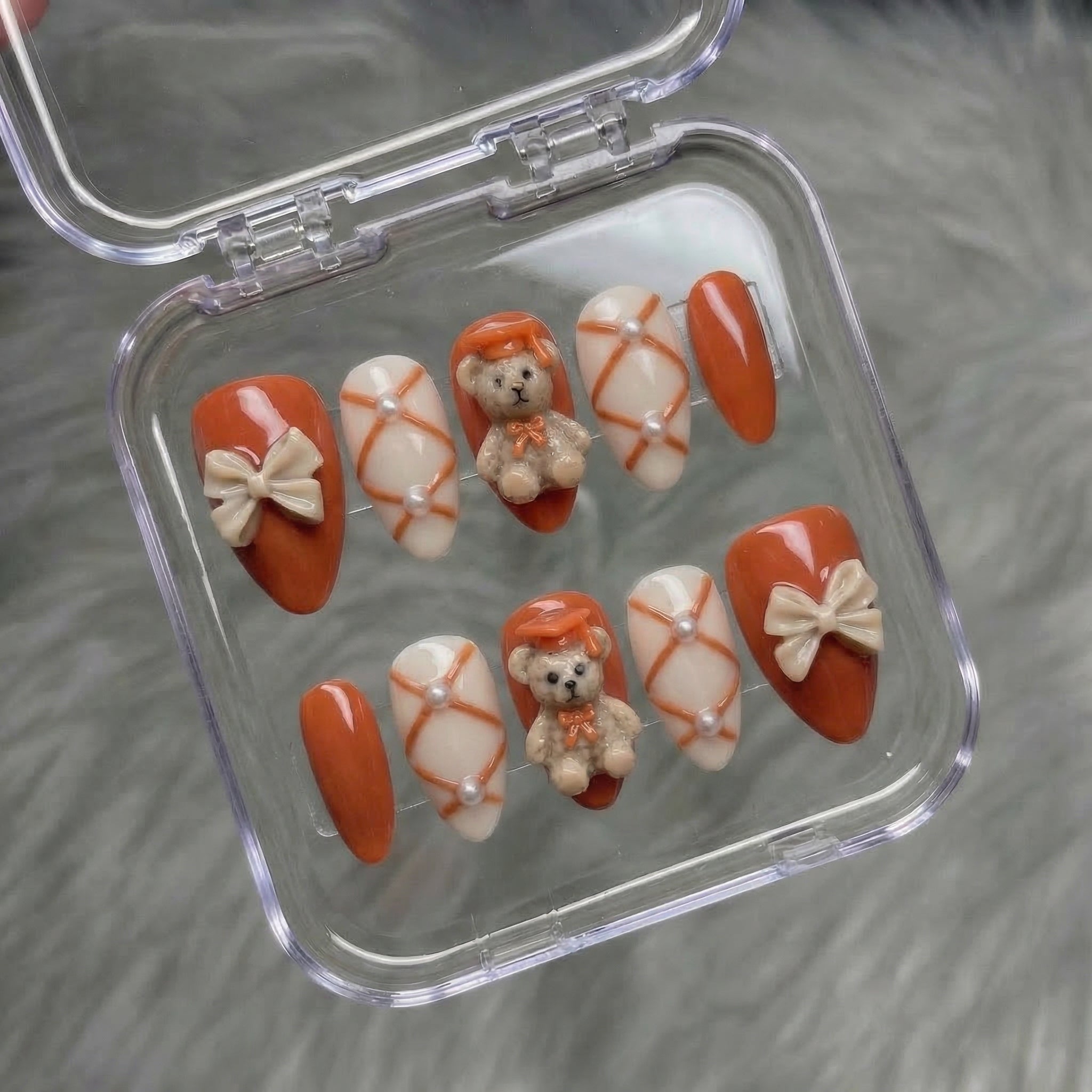 Scholar Bear press-on nails worn on hand – almond shape by Handora