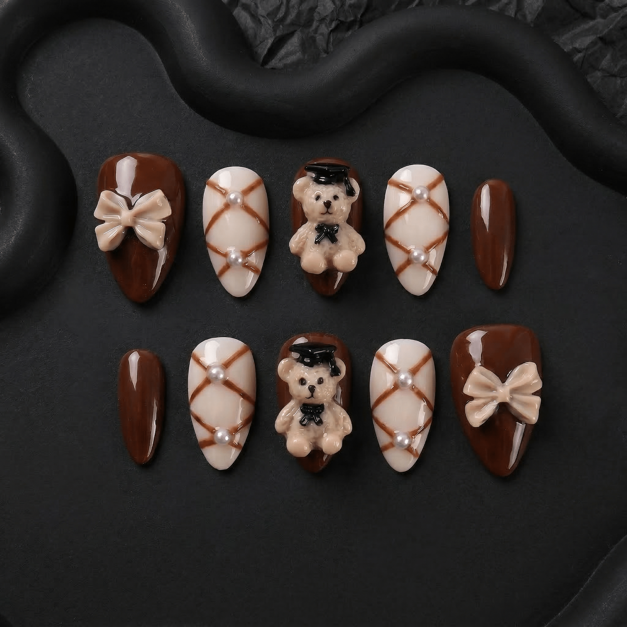 Scholar Bear press-on nails worn on hand – almond shape by Handora