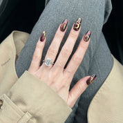 Scorpio Mystique press-on nails worn on hand – almond shape by Handora