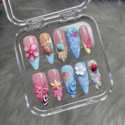 Seaside Blossom press-on nails worn on hand – almond shape by Handora