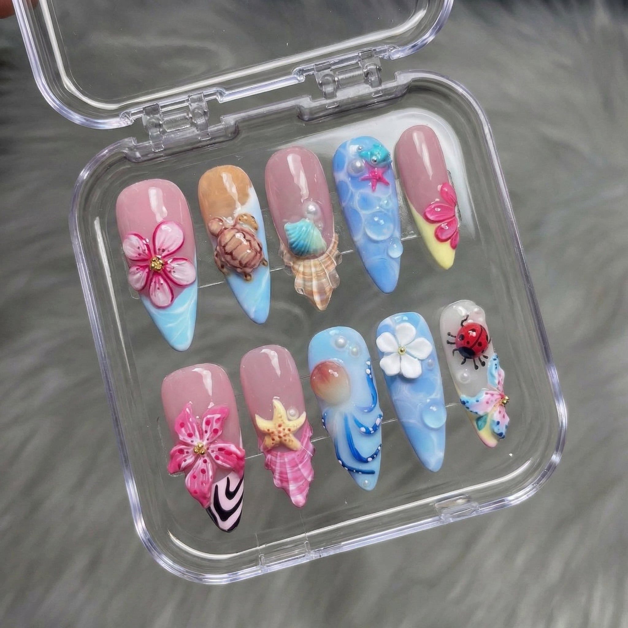 Seaside Blossom press-on nails worn on hand – almond shape by Handora