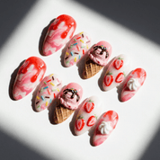 Strawberry Sundae press-on nails worn on hand – almond shape by Handora