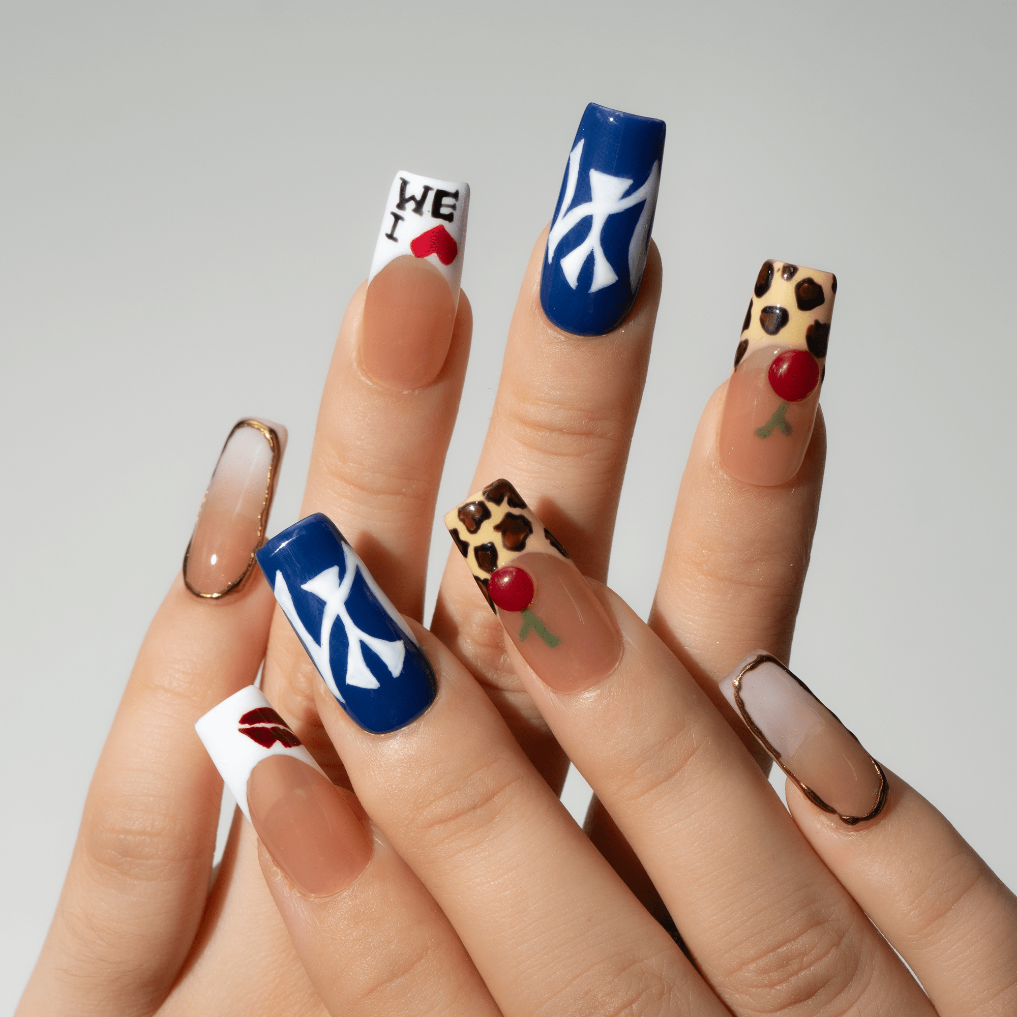 Street Pop press-on nails worn on hand – almond shape by Handora