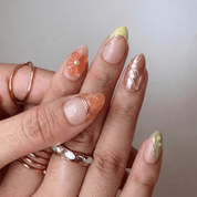 Summer Peach press-on nails worn on hand – almond shape by Handora