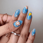 Summer Puppy press-on nails worn on hand – almond shape by Handora
