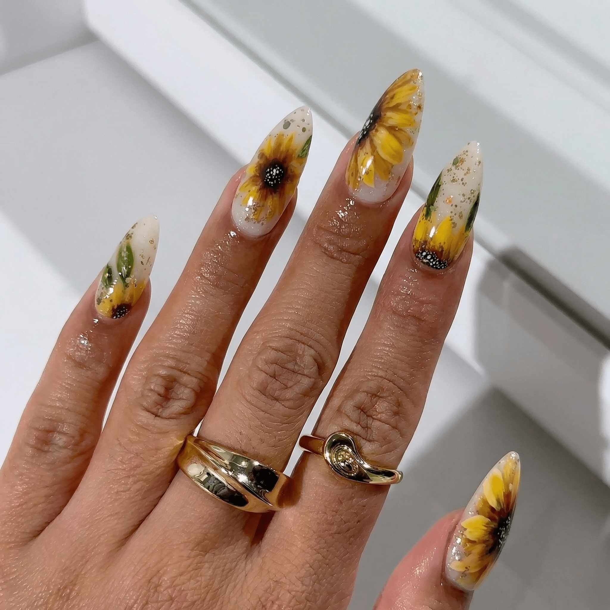 Sunbeam Petals press-on nails worn on hand – almond shape by Handora