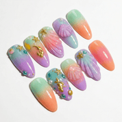 Sunset Mermaid press-on nails worn on hand – almond shape by Handora
