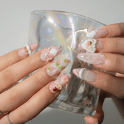 Sweet Berry press-on nails worn on hand – almond shape by Handora