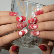 Sweet Blossom press-on nails worn on hand – almond shape by Handora