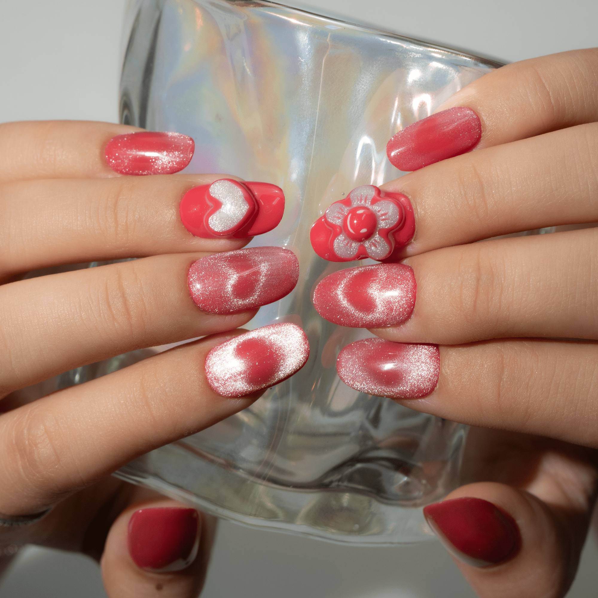 Sweet Blossom press-on nails worn on hand – almond shape by Handora