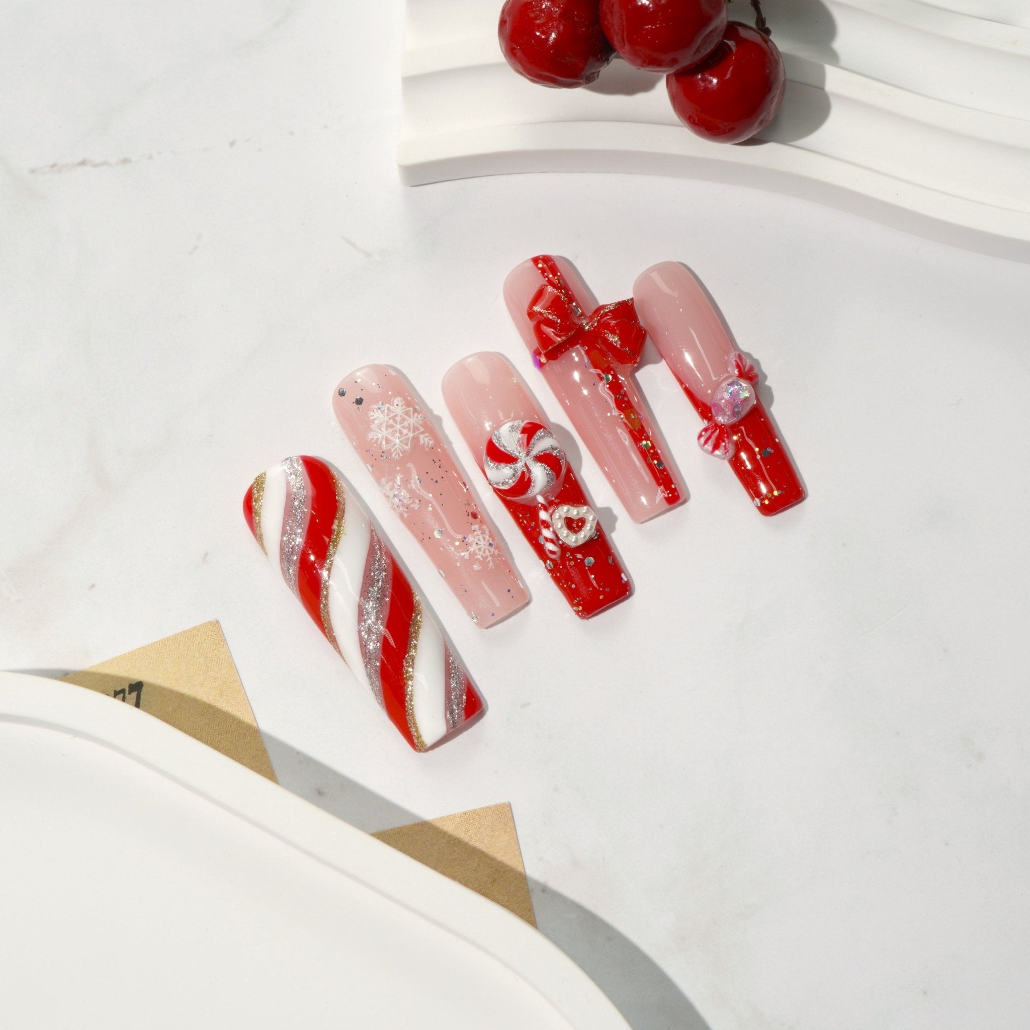 Sweet Noel press-on nails worn on hand – square shape by Handora