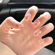 Sweet Peachy press-on nails worn on hand – almond shape by Handora