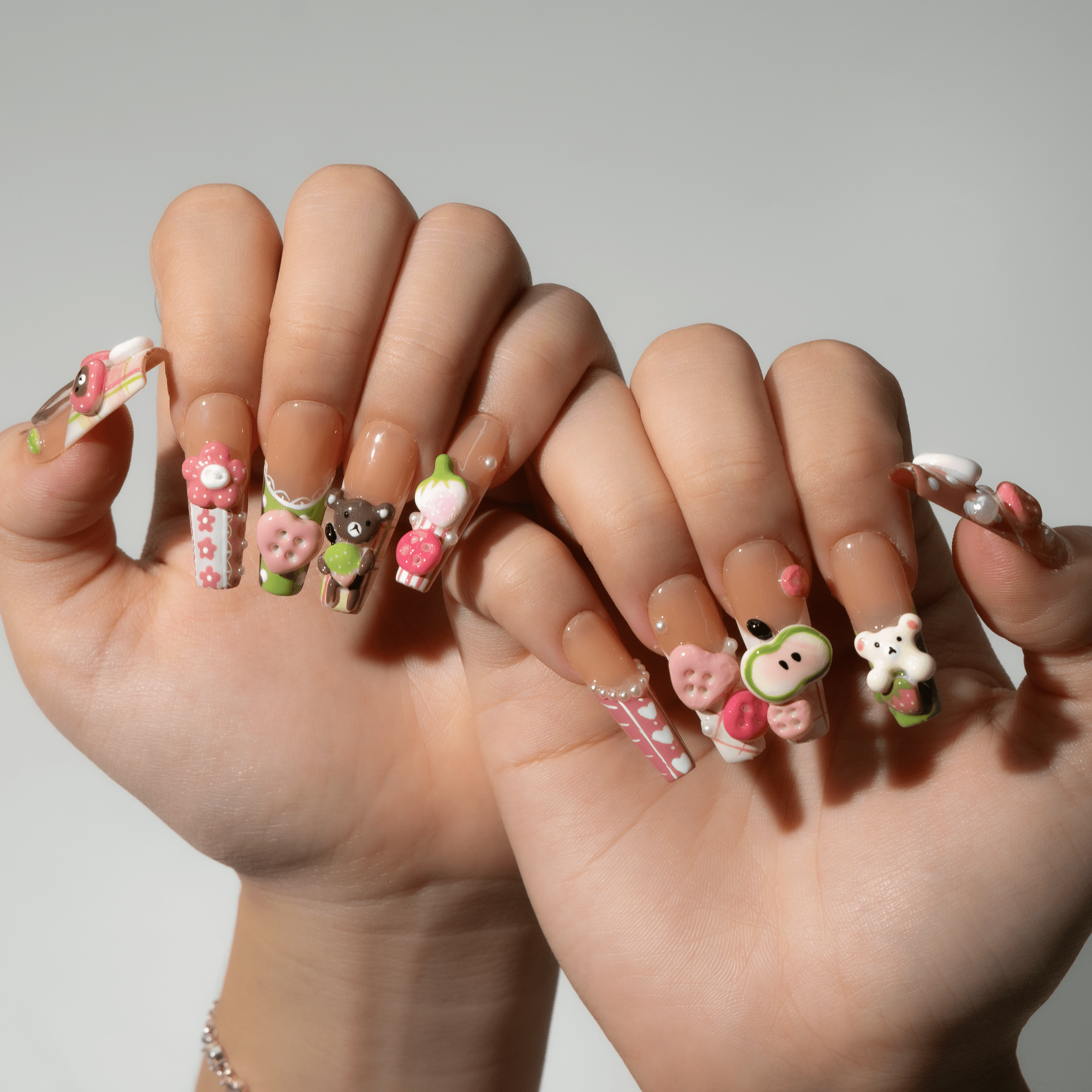 Sweet Picnic press-on nails worn on hand – almond shape by Handora