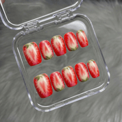Sweet Strawberry press-on nails worn on hand – almond shape by Handora