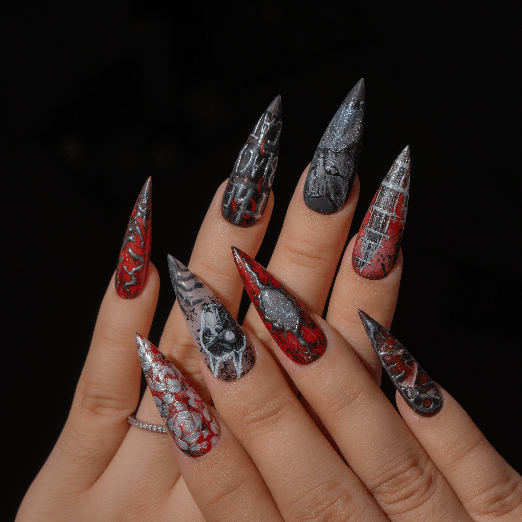 The Black Cat press-on nails worn on hand – almond shape by Handora