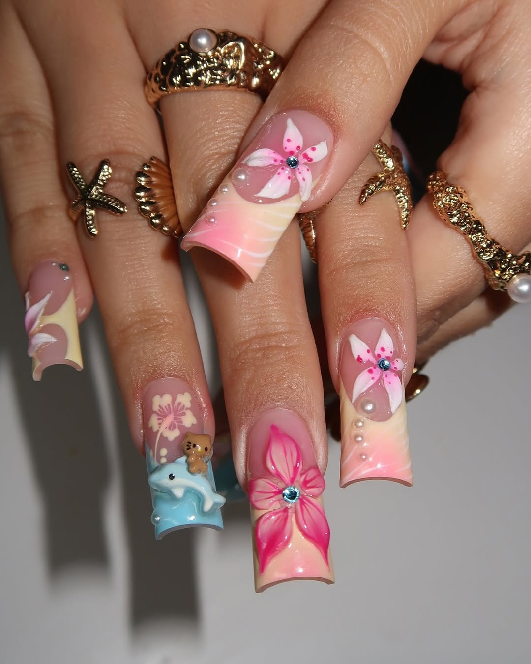 Ocean Hibiscus press-on nails worn on hand – almond shape by Handora
