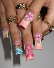 Ocean Hibiscus press-on nails worn on hand – almond shape by Handora