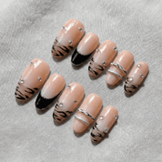 Tiger Chrome press-on nails worn on hand – almond shape by Handora