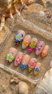 Tropical Floral press-on nails worn on hand – almond shape by Handora