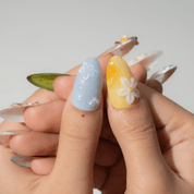 Tropical Monkey press-on nails worn on hand – almond shape by Handora
