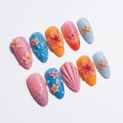 Tropical Shell press-on nails worn on hand – almond shape by Handora