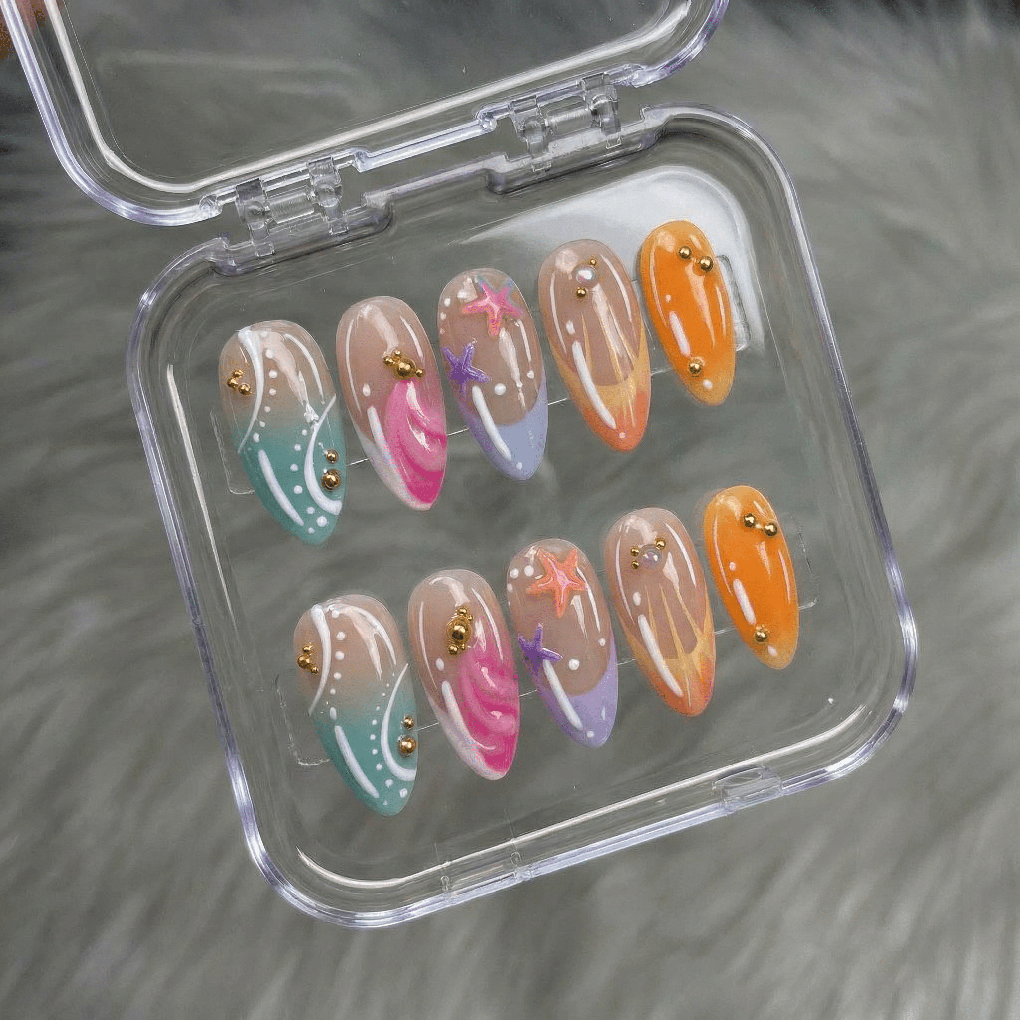 Tropical Siren press-on nails worn on hand – almond shape by Handora