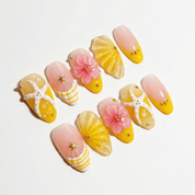 Tropical Starfish press-on nails worn on hand – almond shape by Handora