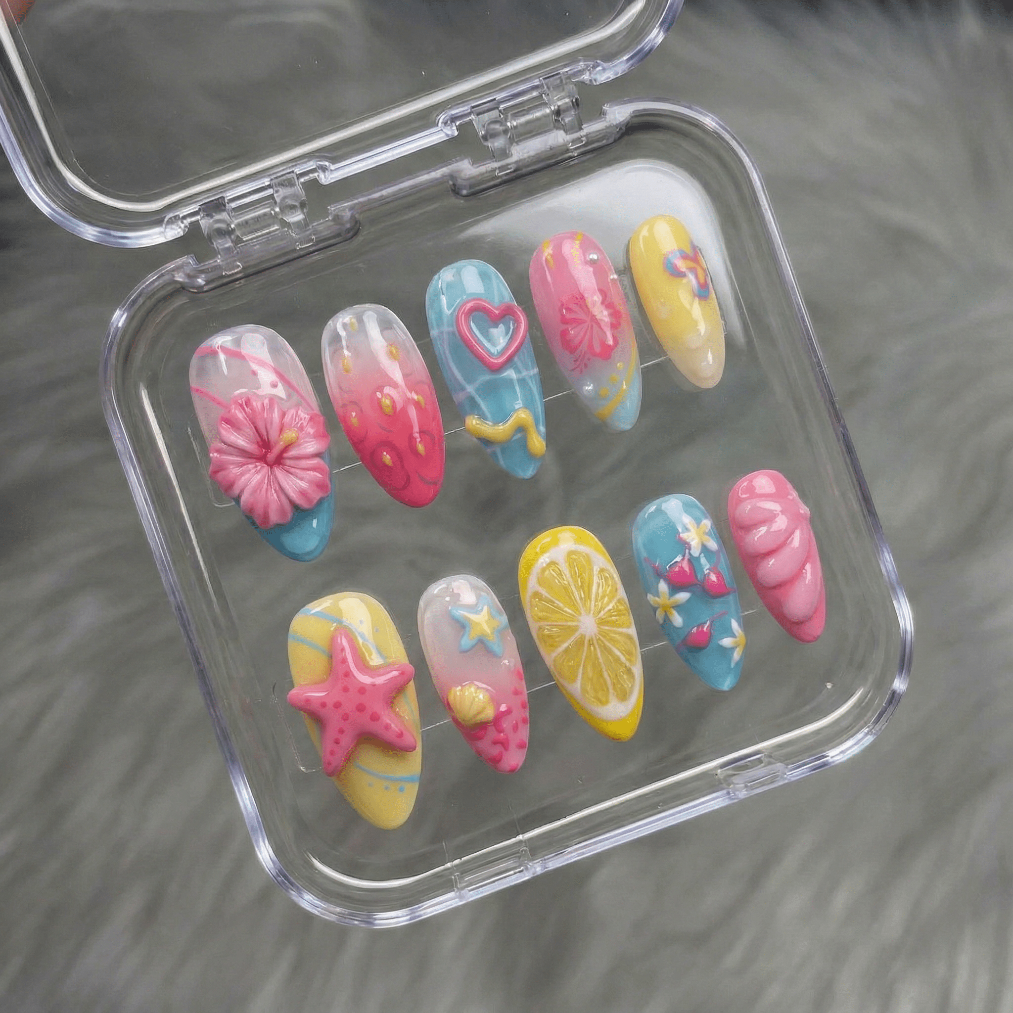 Tropical Summer press-on nails worn on hand – almond shape by Handora