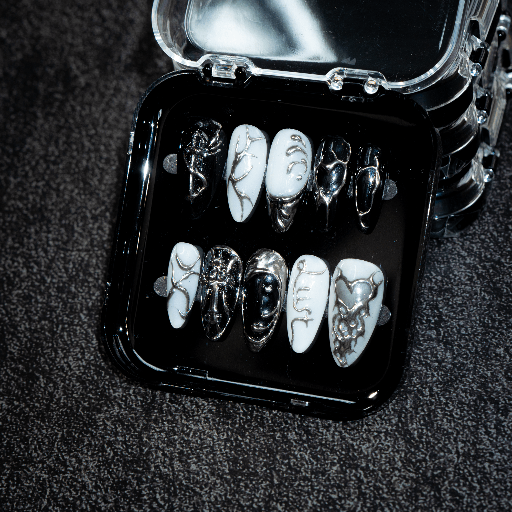 Vampire Chrome press-on nails worn on hand – almond shape by Handora