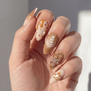 Vanilla Latte press-on nails worn on hand – almond shape by Handora