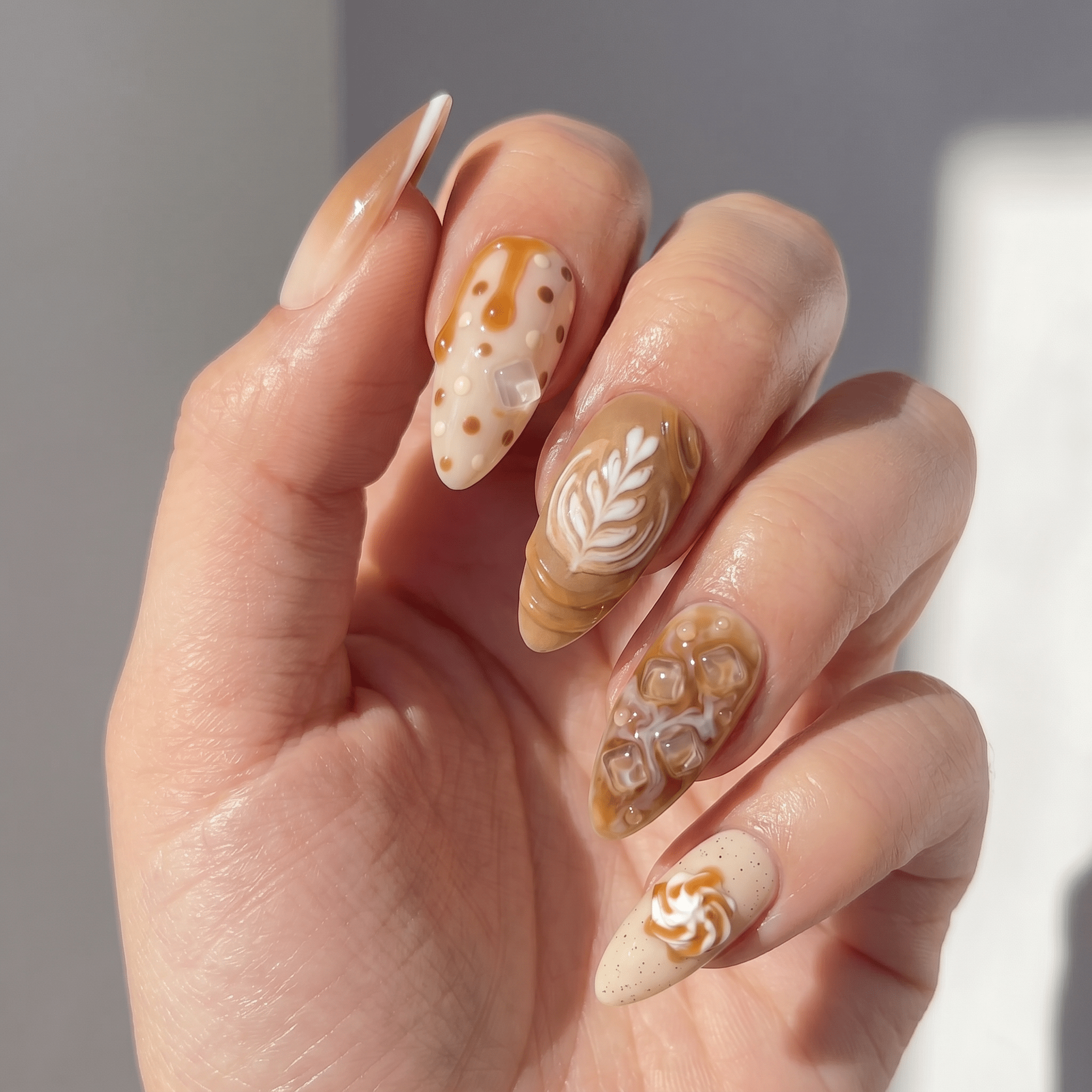Vanilla Latte press-on nails worn on hand – almond shape by Handora