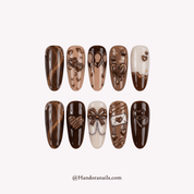 Velvet Mocha press-on nails worn on hand – almond shape by Handora