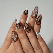 Wild Bloom press-on nails worn on hand – almond shape by Handora